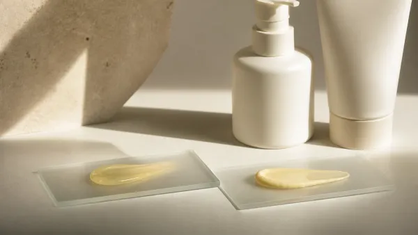 Two generic yellow skincare textures beside unbranded opaque containers